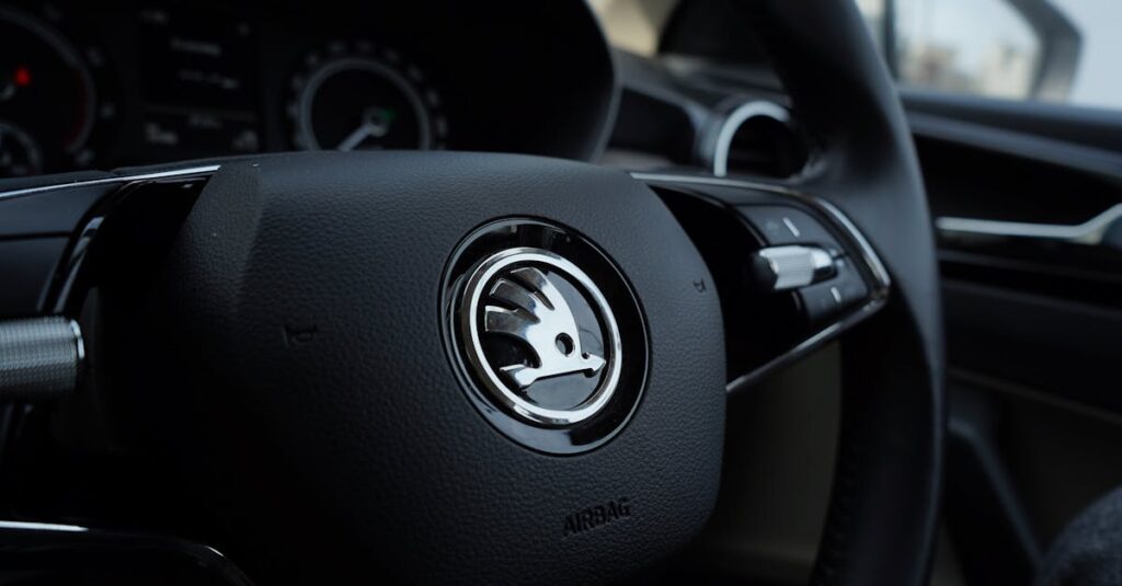 Detailed view of a Skoda steering wheel inside a vehicle, showcasing modern car design.