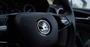 Detailed view of a Skoda steering wheel inside a vehicle, showcasing modern car design.